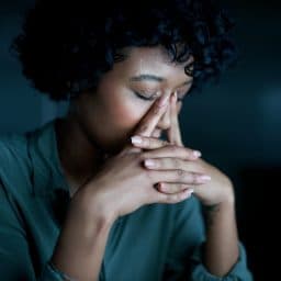 Woman experiencing sinus pressure and allergies.