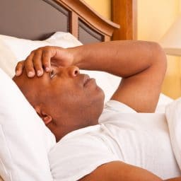 Man struggling to sleep.