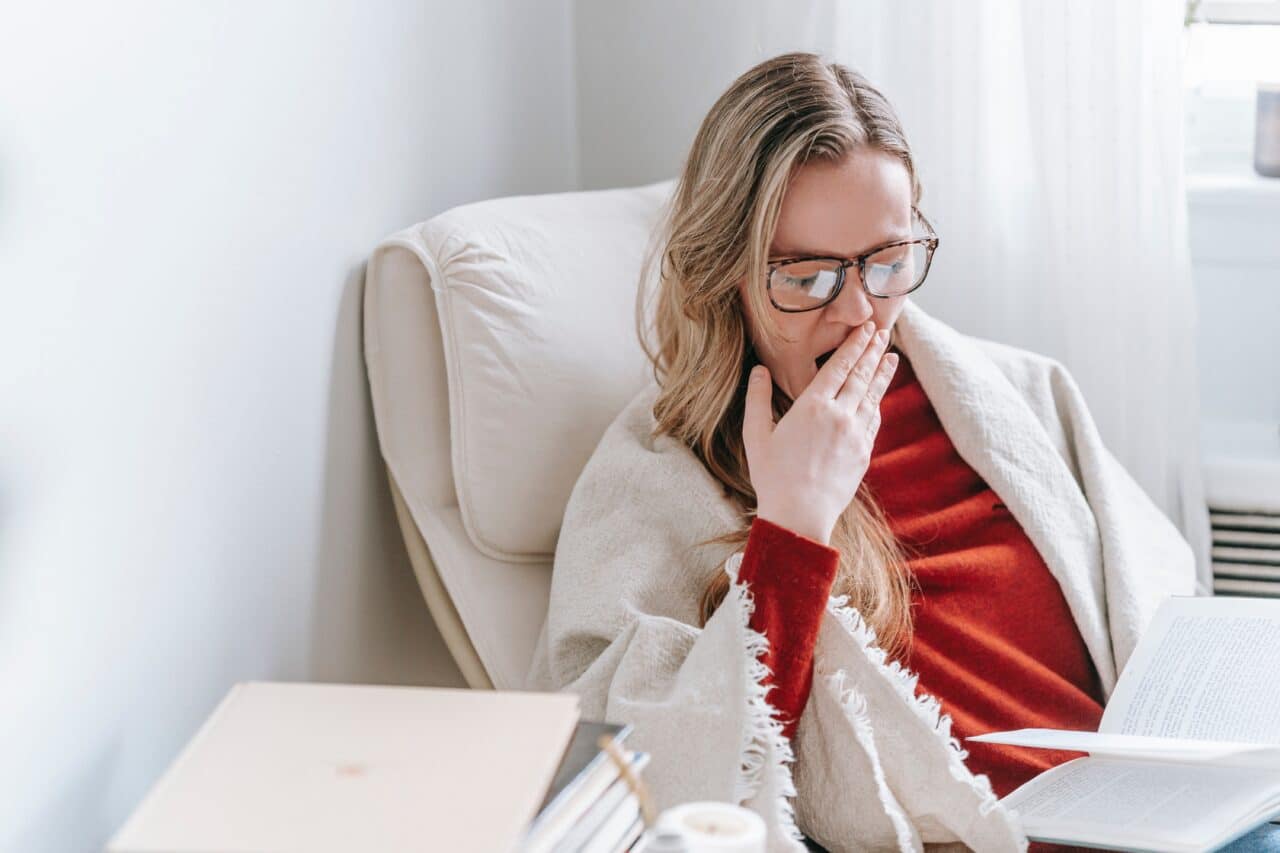 Woman yawning at home.