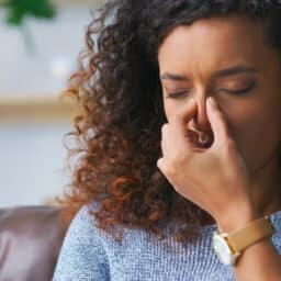 Woman massages nose