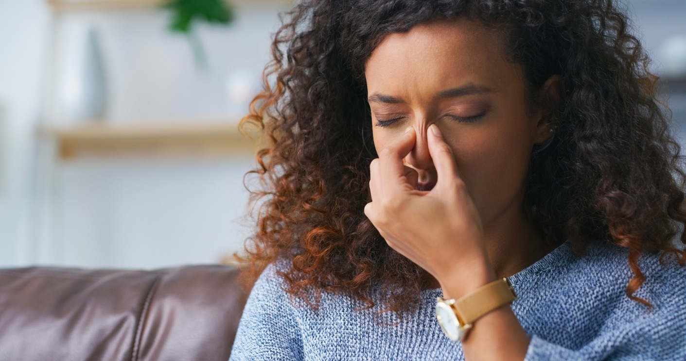 Woman massages nose