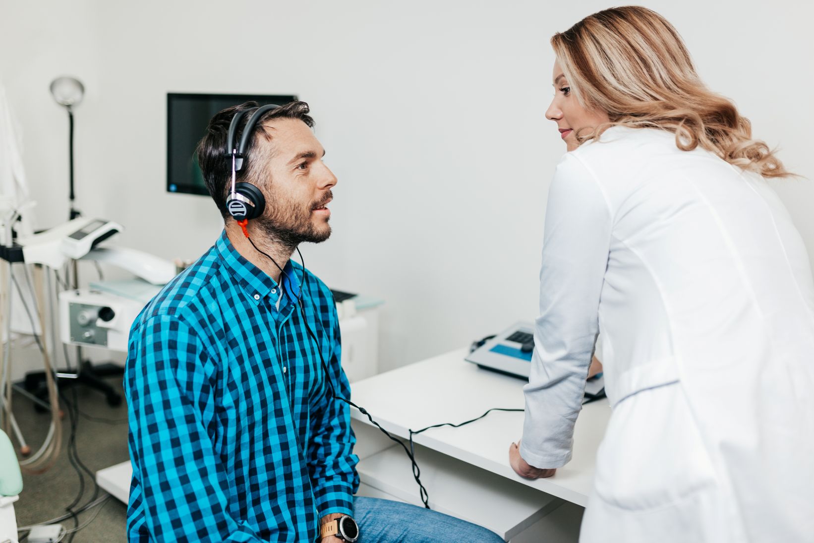 audiology patient completing hearing test man being tested and treated for hearing loss