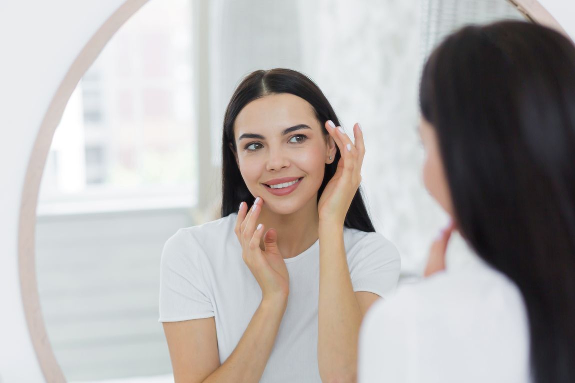 woman looking at herself in the mirror