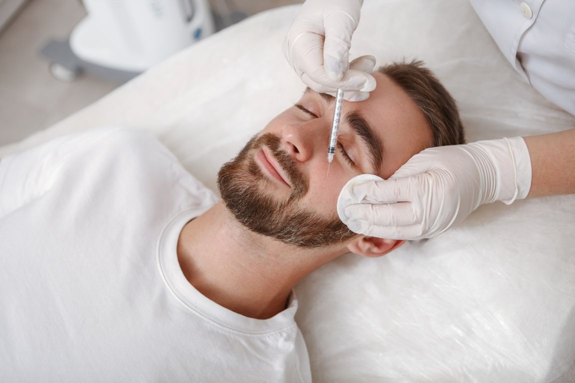 man laying down receiving juvederm injection in cheek
