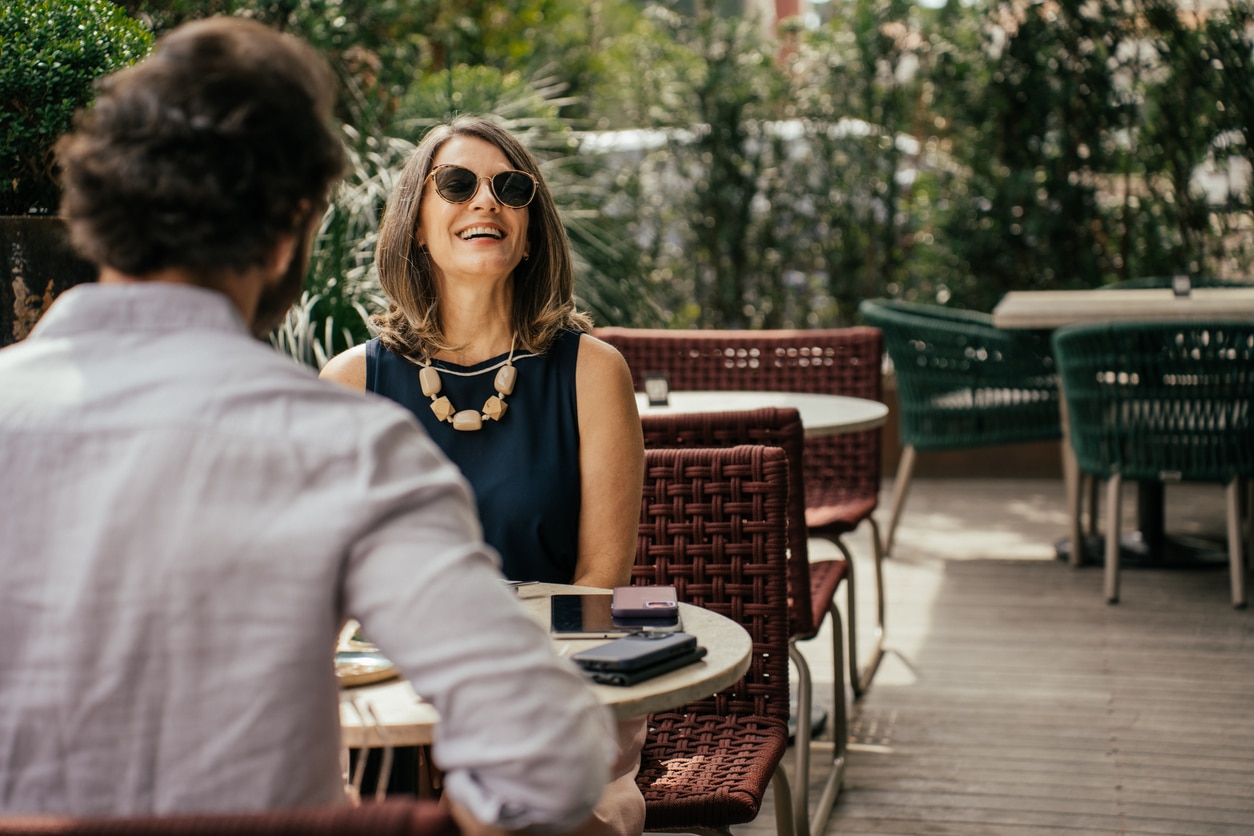 Couple eating outside at a restaurant .