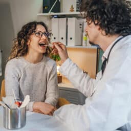 ENT examining a woman's throat