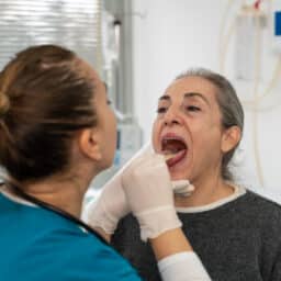 ENT examining a patient's throat