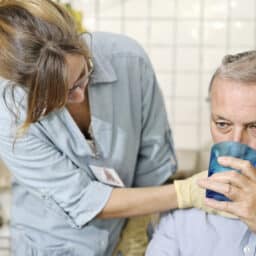 Healthcare worker checking man's throat