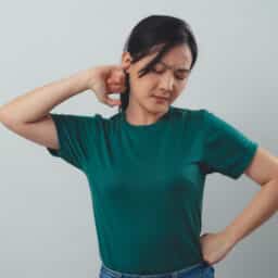Woman trying to unplug clogged ear