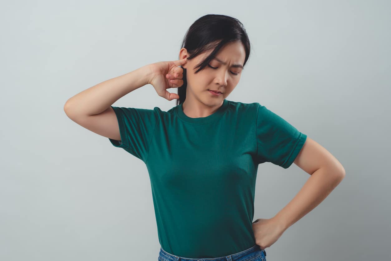 Woman trying to unplug clogged ear.