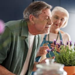 Senior Couple Enjoying the Aroma of Fresh Lavender at Home