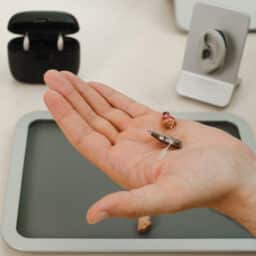 Very small hearing aid in hands