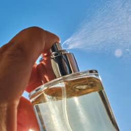 Spraying perfume against the sky