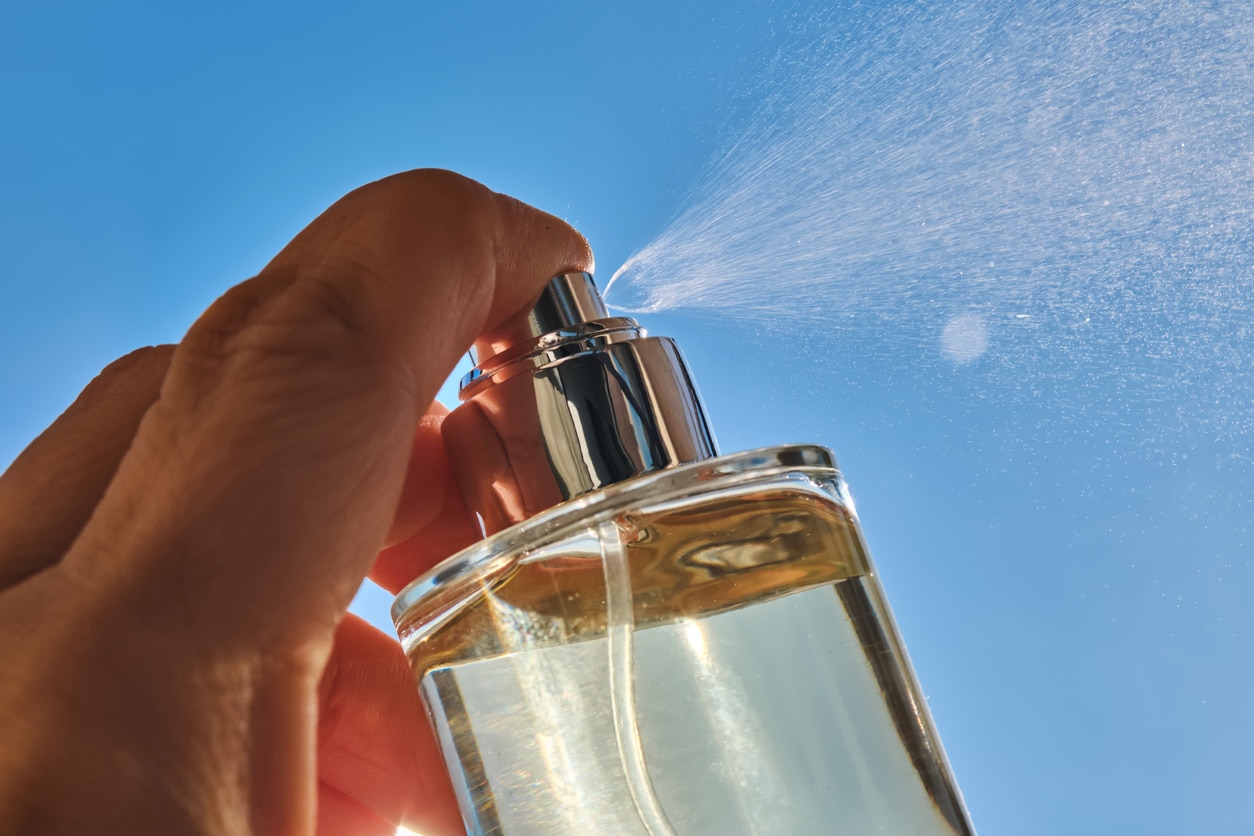 Spraying perfume against the sky