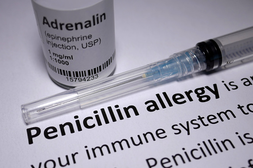 Photo of a penicillin allergy sheet and an epinephrine injection.