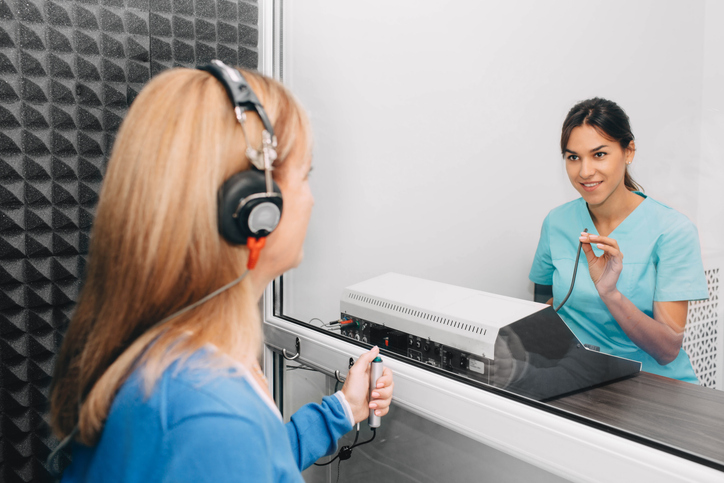 Woman in a hearing test with an audiologist.